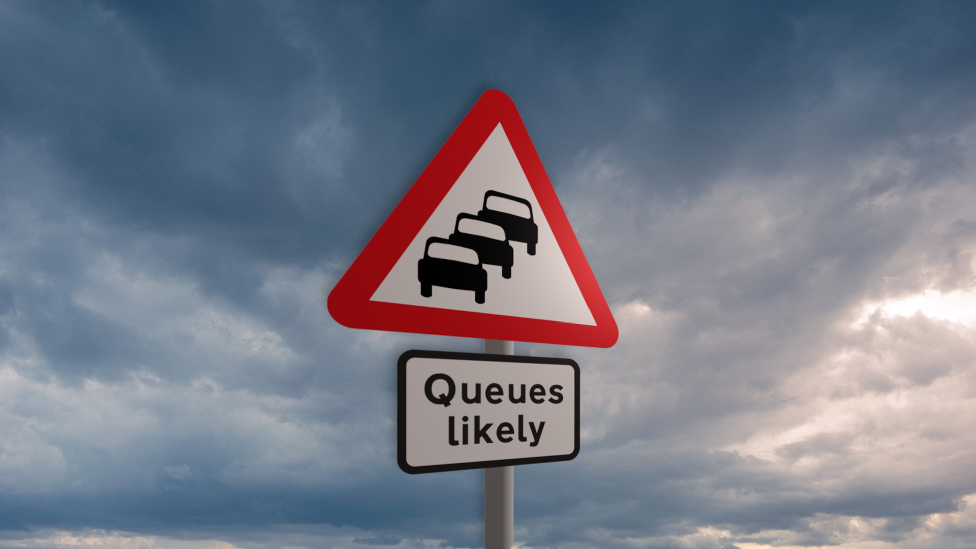 A UK road sign against a cloudy sky