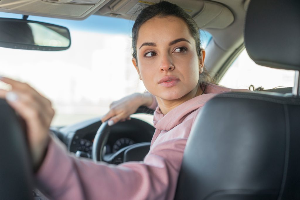 A female driver reversing a car