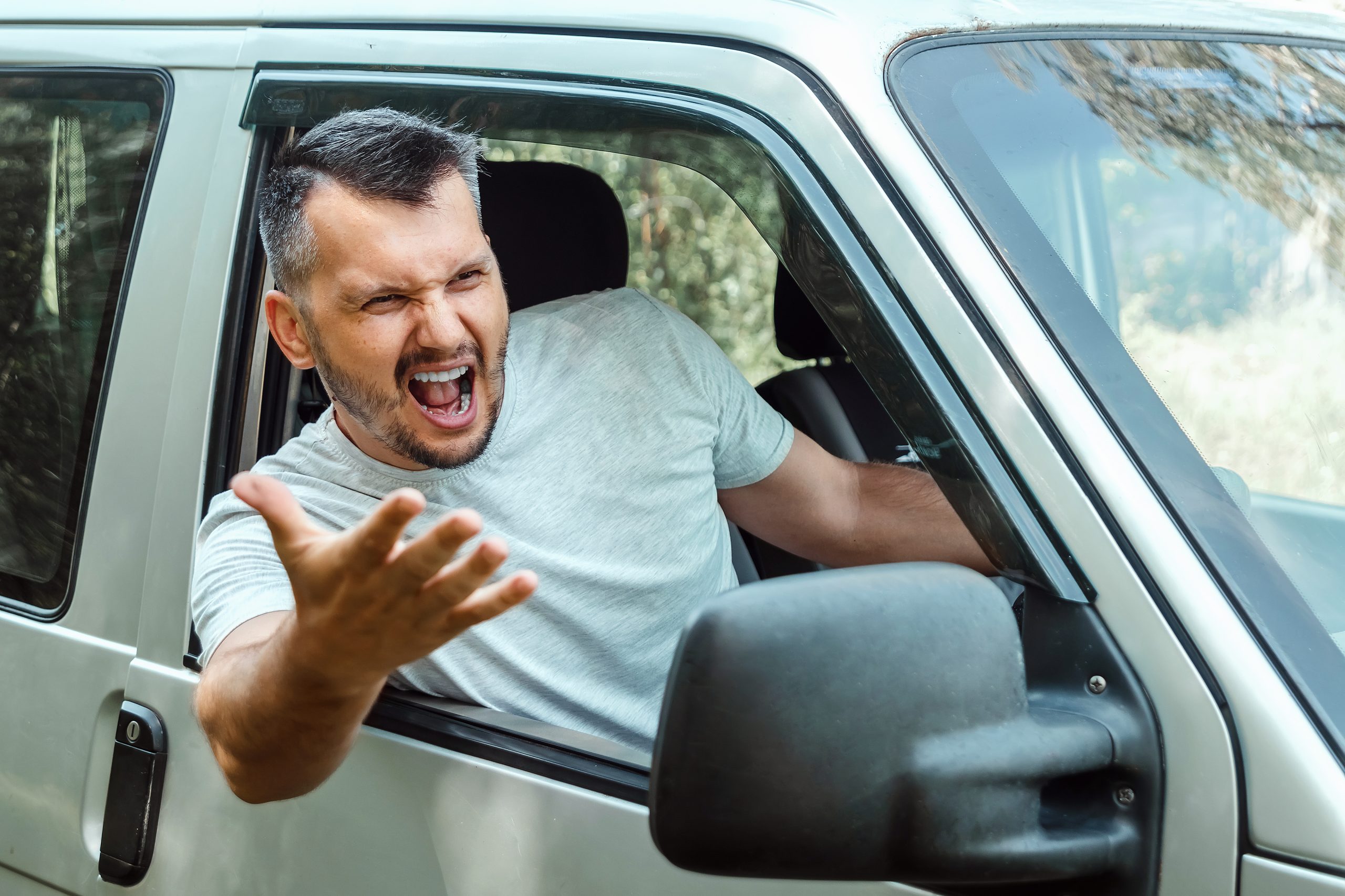 outraged car driver shouting out of the window